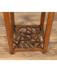 Brown elmwood lamp table with single drawer and cracked ice shelf, positioned on a wooden floor indoors.
