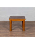 Natural wood Chinese vintage side table on wooden floor against white brick wall.