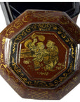 Dark reddish-brown lacquered octagonal Chinese wedding basket with gilt ornate figures and patterns, close-up view.