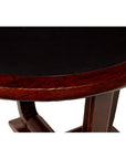 Close-up of circular side table with dark tabletop, Chinese elmwood trim, and detailed legs visible.