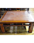 Brown rattan coffee table on wooden floor indoors.