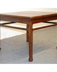 Light wood coffee or side table with simple lines and horsehoof legs, placed on a light wood floor.