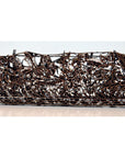 Copper metal rectangular box with intricate openwork floral patterns, close-up on plain background.