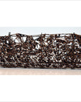 Copper metal rectangular box with intricate openwork floral patterns, close-up on plain background.
