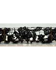 Copper metal rectangular tray with ornate floral scrollwork, antique ink block style, close-up view.