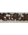 Close-up of dark brown copper barrette with floral and leaf openwork, batik ink block inspired.