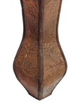 Copper coffee table with ornate embossed floral and leaf patterns on surface, close-up view.