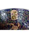 Close-up of a blue, gold, and green porcelain Ming bowl with intricate floral patterns, in very good condition.