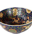 Blue, gold, and green porcelain Ming bowl with intricate floral patterns, close-up view.