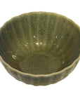 Celadon porcelain bowl with textured crackled glaze and wavy rim, shown on a white background.