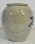 Close-up of round beige ceramic vase with fine crackle glaze and blue calligraphy, antique Japanese style.