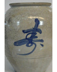 Close-up of white ceramic crackle vase with hand-painted blue Asian calligraphy.