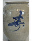 Close-up of white ceramic crackle vase with hand-painted blue Asian calligraphy.