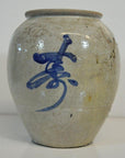 Close-up of a glossy blue and white Japanese crackle vase with bold abstract brushstroke on the front.