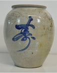 Close-up of a glossy blue and white Japanese crackle vase with bold abstract brushstroke on the front.