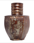 Dark metal pitcher with ribbed neck and patina finish against a white background.