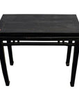 Dark stained wood altar table with straight legs, small red dot on top corner, close-up view.
