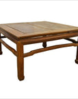 Brown elm wood square coffee table with sturdy legs and smooth surface, 19th-century style, on white background.