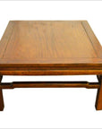 Brown Yumu wood coffee table with straight legs, hand-carved 19th century, against a plain background.