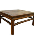 Natural Yumu wood square coffee table with hand-carved legs and natural finish on a white background.