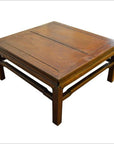 Brown Yumu wood coffee table with simple design and visible grain on a white background.