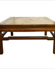 Brown Yumu wood coffee table with simple sturdy legs and smooth flat tabletop, shown on a white background.