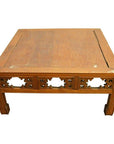 Brown elm wood coffee table with hand-carved designs and slightly tapered legs in antique Chinese style.