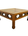 Natural elm wood coffee table with carved latticework sides and sturdy, slightly tapered legs.