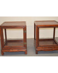 Brown wooden side table with open sides and a lower shelf, traditional design, studio background.