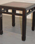 Dark wood Elmwood stool with sturdy legs and burlwood inlay accents visible beneath the seat.
