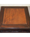 Dark brown elmwood stool with burl wood inlay and simple raised border, close-up view.