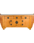 Natural wood Qing Dynasty sideboard with carved spandrels, three drawers, two doors, and round metal handles.