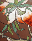 Close-up of a vintage Chinese ceramic flower vase with floral design, cracked glaze, and chipped paint.