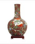 Brown ceramic Chinese vintage flower vase with long neck, floral and fruit design, on wooden stand.