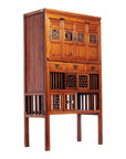 Dark wood Chinese cabinet with intricate carved doors, drawers, and lower section open latticework, front view.