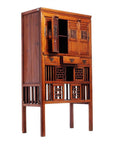 Dark wood Chinese cabinet with carved fretwork, butterfly hardware, drawers, and open slatted shelves.