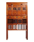Brown wood Chinese cabinet with carved fretwork doors, butterfly hardware, and four drawers, front view.