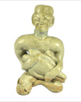 Brown glazed terracotta fertility doll, seated with animal, wearing square hat, vintage style, close-up.