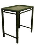 Close-up of a green bamboo-style side table with legs and edges designed to resemble bamboo stalks.