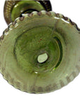 Green glass oil lamp base with scalloped edge and raised center, close-up from below, very good condition.