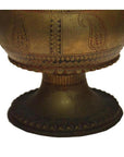 Silver hammered metal urn with etched patterns on round pedestal base, against a plain white background.
