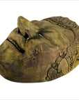 Close-up of hand carved wood Balinese theater mask with closed eyes and intricate patterned sides, very good condition.