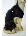 Close-up of a black and white hand carved vintage cat statue, wood with worn and chipped areas, in good condition.