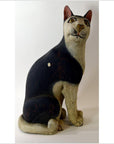 Black and white painted ceramic cat figurine in good vintage condition, close-up.