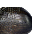 Close-up of dark wood hand-carved fish sculpture with detailed scales and one visible eye, in good condition.