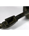 Close-up of a hand-carved metal animal head spout attached to a Saringda lute from Northern India on white background.
