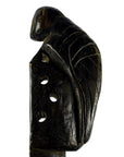 Dark wood carved Indian Saringda lute with a bird figure on top and three holes, folk fiddle, close-up view.