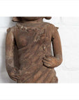 Brown hand-carved wood Hindu deity statue torso, draped hands, close-up, from Gujarat.