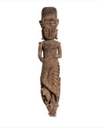 Brown carved wood statue of crowned Hindu deity in draped garment, on white background.