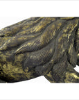 Close-up of gold and dark bronze hand carved Indonesian beast sculpture with detailed fur and part of a leg.
